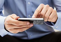 Closeup of male hands using smartphone